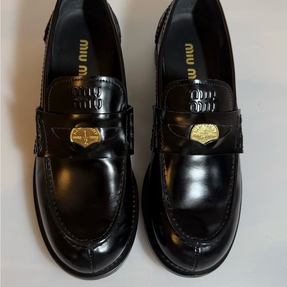 Miu Miu Black and Gold Leather Slip-Ons
